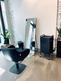 Friseur Berlin Mitte Anja Kieselbach Salon Frisiersessel am Fenster Blick geht auf einen großen Spiegel an der Wand